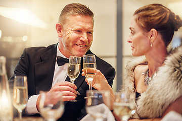 Image showing Success, toast or happy couple in a party in celebration of goals, achievement or new year at luxury event. Motivation, smile or people cheers with champagne drinks or wine glasses at fun dinner gala