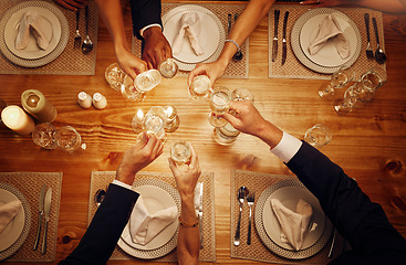 Image showing Champagne, glasses and cheers for celebration at a dinner for festive, new years eve or birthday. Party, event and top view of wine for a celebrating toast by a dining table at a restaurant or home.