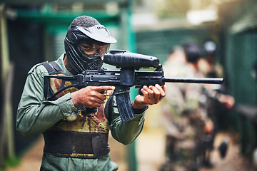 Image showing Paintball gun and black man player portrait with safety uniform for outdoor shooting game. Competitive tournament guy with helmet and camouflage vest ready for shooter sport and activity.