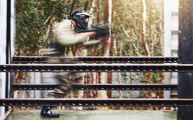 Image showing Paintball, gun and sport speed of a man doing workout and fitness performance for soldier training. Cardio, shooting and camouflage games of a young athlete with energy and cardio for outdoor game