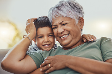 Image showing Happy, grandmother and grandchild on a sofa, smile and laugh, love and family while bonding in their home. Relax, grandma and child embrace, funny and joke on a couch, loving and sweet in living room