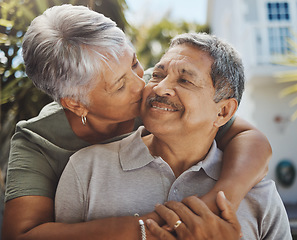 Image showing Black senior couple, hug and kiss for love, retirement holiday and happiness outdoor together. African man, woman kissing and happy quality time or marriage relationship bonding on travel vacation