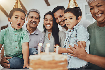 Image showing Kid, birthday candles and child with cake at a house at a party with food and celebration. Children, celebrate event and family together in a kitchen with a smile and happiness with parent love