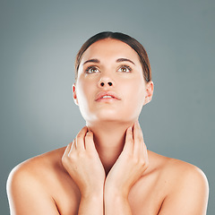 Image showing Woman, beauty and hands on neck in skincare satisfaction for cosmetic treatment against grey studio background. Face of beautiful female touching soft, smooth or perfect skin for healthy wellness