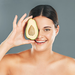 Image showing Avocado skincare, woman and cosmetics wellness for healthy diet, happy results or clean glowing skin on grey background. Beauty portrait, smile or model face, facial makeup or fresh fruit for health