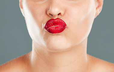 Image showing Kiss face zoom, lipstick and woman lips with makeup, red cosmetics and pout isolated on studio background. Healthy skin, beauty and skincare with cosmetic care, wellness and facial glow with shine