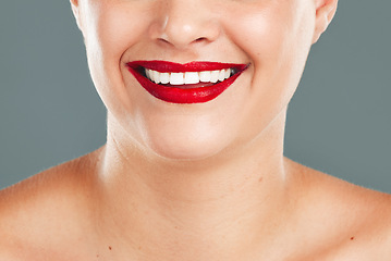 Image showing Woman, red lipstick and smile for makeup cosmetics, skincare or beauty against a grey studio background. Happy female model smiling with cosmetic lips or mouth for beautiful color aesthetic treatment