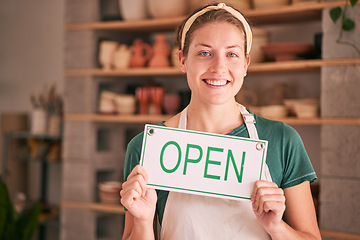 Image showing Woman, small business and open sign for creative startup, welcome or entrepreneurship at retail store. Portrait of happy owner in pottery shop with smile holding opening board in ready for service