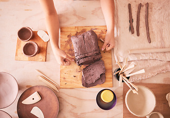 Image showing Pottery woman and hands with clay top view at table with tools for production and manufacturing. Sculptor process and handmade ceramic workshop of small business owner and artist dividing product.