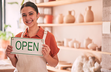 Image showing Woman, pottery art and small business with open sign for creative startup, welcome or entrepreneurship at retail store. Portrait of happy entrepreneur with smile holding opening board ready at shop