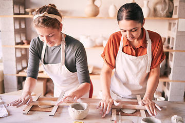 Image showing Pottery, design and small business people in workshop teamwork, collaboration and startup production. Clay, manufacturing and creative woman, artist or partner working together on sculpture process