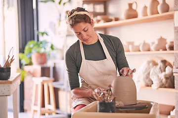 Image showing Pottery wheel, mold and woman design sculpture, clay manufacturing process or art product. Creative retail store, craft process and startup small business owner, employee or artist in studio workshop