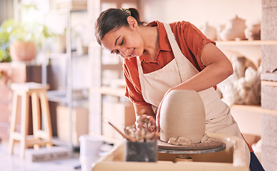 Image showing Pottery wheel, workshop and woman mold sculpture design, clay manufacturing production or art product. Creative retail store, craft process or startup small business owner, worker or artist in studio