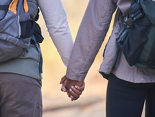 Image showing Holding hands, couple outdoor hiking with support and trust, fitness and adventure with commitment. Travel, exercise and people together in nature, health and wellness with partnership back view