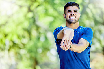 Image showing Exercise, mockup or stretching arm with a man outdoor in nature for a warm up before a workout. Fitness, mock up and training with a male athlete on a natural green background for health or cardio