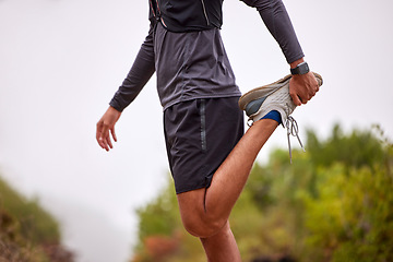 Image showing Exercise, balance and man stretching legs on nature trail for running, marathon training and cardio workout. Sports, healthy body and torso of male athlete warm up for wellness, energy and fitness