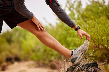 Image showing Running, stretching legs and man on nature trail for fitness, marathon training and cardio workout. Sports mockup, healthy body and shoes of male runner warm up for wellness, exercise and performance