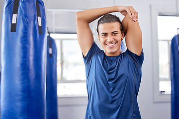 Image showing Portrait, fitness and stretching with a boxing man in a gym getting ready for a workout for health. Exercise, smile and warm up with a happy male boxer training as a fighter in a performance center