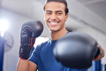 Image showing Fitness, portrait or happy boxer in training, cardio workout or exercise in a sports gym or health club. Face, man or healthy fighter in boxing gloves exercising with motivation, focus or goals