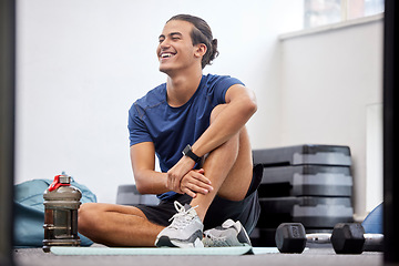 Image showing Fitness, relax or happy sports man at gym after training, workout or exercise resting on a break. Tired, smile or healthy athlete with fatigue relaxing on a mat alone after exercising for body goals