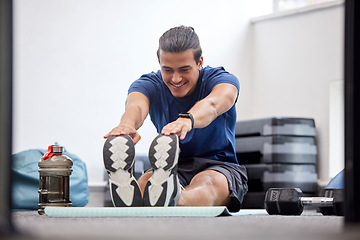 Image showing Fitness, exercise or man stretching legs to start training, workout or warm up to relax muscles in body. Wellness, flexible or healthy sports athlete with a happy smile exercising in a gym in Brazil