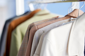 Image showing Shirts, clothes and closet in a home with fashion, style and organized. Neat, tidy and clean work clothing in a wardrobe for lifestyle, selection and choice in a bedroom for organizing and changing