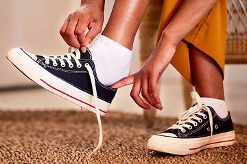 Image showing Hands, shoes and lace getting ready for walk, travel or shopping on the carpet floor or mat at home. Hand of person tying laces, fitting or putting on shoe in preparation for walking, journey or trip