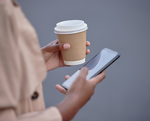 Image showing Business phone, hands and black woman with coffee, internet browsing or social media. Mobile, tea and female employee with smartphone for networking or web scrolling isolated on a gray background.