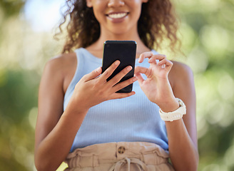 Image showing Phone, social media and woman online texting on the internet, web or app outdoors in a park. Closeup, mobile and surfing on a website by a happy person connecting due digital communication