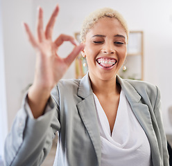 Image showing Portrait, tongue and emoji with a business black woman winking in her office at work to gesture a perfect hand sign. Face, motivation and succes with a female employee feeling happy or proud