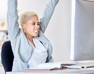 Image showing Winner, success and motivation with a business black woman cheering while working in an office. Wow, winning and celebration with a female employee sitting arms raised after reaching a target or goal