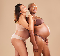 Image showing Pregnant, bonding or laughing women on studio background in body empowerment, support or community. Happy smile, diverse or pregnancy friends in underwear and fun joke, baby or family planning mockup