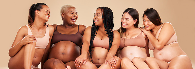 Image showing Laughing, bonding and pregnant women sitting on floor in community, diversity support or body wellness. Smile, happy and pregnancy friends in underwear with funny, comedy or comic joke for healthcare