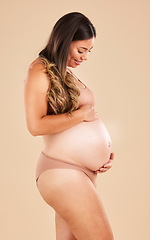 Image showing Pregnancy care, underwear and studio woman with smile, happy and excited for baby, stomach growth or motherhood. Gynecology, maternity or pregnant model feeling abdomen with healthcare, love and hope