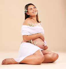 Image showing Pregnancy, pregnant woman and smile with flowers sitting, beauty and glow isolated on studio background. Skin, shine and natural cosmetics with nature, happy mother with prenatal cosmetic care mockup