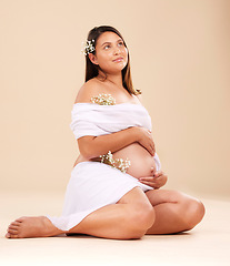 Image showing Pregnancy, pregnant woman with flowers sitting, beauty and glow isolated on studio background. Skin, shine and natural cosmetics with nature, happy mother with prenatal cosmetic care mockup