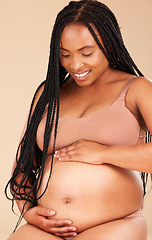 Image showing Pregnancy feeling, lingerie or relax woman with studio smile, happy and excited for baby, stomach growth or motherhood. Gynecology, maternity or pregnant African model with healthcare, love and hope