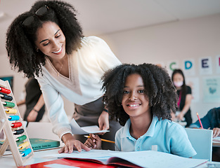 Image showing Young child learning maths, happy teacher in classroom with children and knowledge at desk. Female educator writing in workbook, reading kids notebook at school and teaching student with assignment