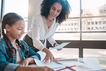 Image showing Help, education or teacher teaching a student in a classroom with learning development or studying. Writing, papers or happy black woman helping, talking or speaking to a creative high school girl