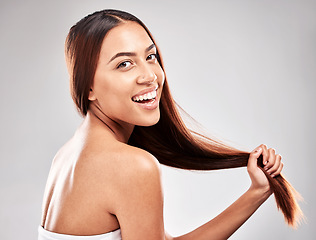 Image showing Portrait, happy and woman in studio with strong hair, healthy and salon treatment on grey background. Face, smile and girl model with shine relax after luxury hairstyle, keratin and isolated