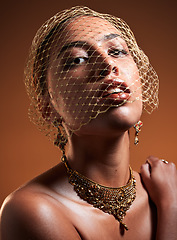 Image showing Beauty, fashion and veil with portrait of woman for gold, jewellery and vintage luxury. Cosmetics, retro and glamour with net on face of girl model for fancy, graceful and accessory in studio