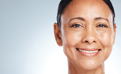 Image showing Mockup, skincare and portrait of a senior woman with beauty isolated on a blue background in studio. Anti aging, health and face of an elderly model happy about facial dermatology on a backdrop
