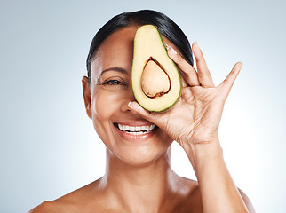 Image showing Beauty, avocado and portrait of woman in studio happy, detox and nutrition on grey background. Fruit, product and face of girl model relax, facial and vegan skincare, skin and and mask while isolated