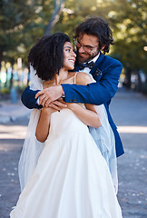 Image showing Happy couple, hug and wedding celebration event outdoor with love, care and commitment. Interracial man and woman at park with trust, partnership and support while together in a healthy marriage