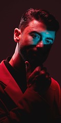 Image showing Future, fashion and reflection, portrait of man with eyes in neon lighting with serious expression on face. Futuristic art, male model and beauty with red and blue studio lights on dark background.