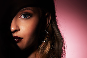 Image showing Glamour makeup and face of woman with spotlight shadow for hidden beauty aesthetic portrait of people zoom in studio. Skincare and dark lipstick style of attractive person in isolated pink background