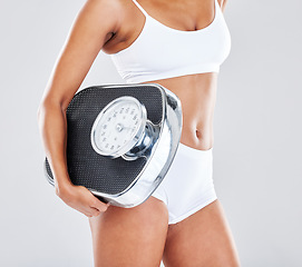 Image showing Wellness, fitness and body of woman with scale in studio after workout, exercise and training to lose weight. Motivation, self care and female model for nutrition, diet routine and healthy lifestyle