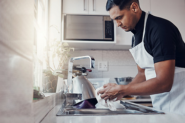 Image showing Cleaning kitchen, washing dishes and a man in house, home or apartment to clean for safety from bacteria. Male cleaner person at sink with a cloth in hands for hygiene and a healthy lifestyle