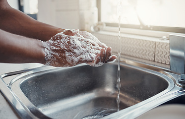 Image showing Cleaning, washing hands and kitchen sink with soap for health, home wellness and safety. Cleaner, bacteria prevention and man getting ready for cooking in a household with water doing house chores