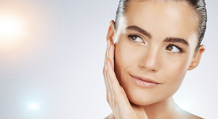 Image showing Skincare, thinking and face of a woman with beauty isolated on a grey studio background. Flare, dermatology and young healthy model with facial wellness, collagen and body detox on mockup backdrop